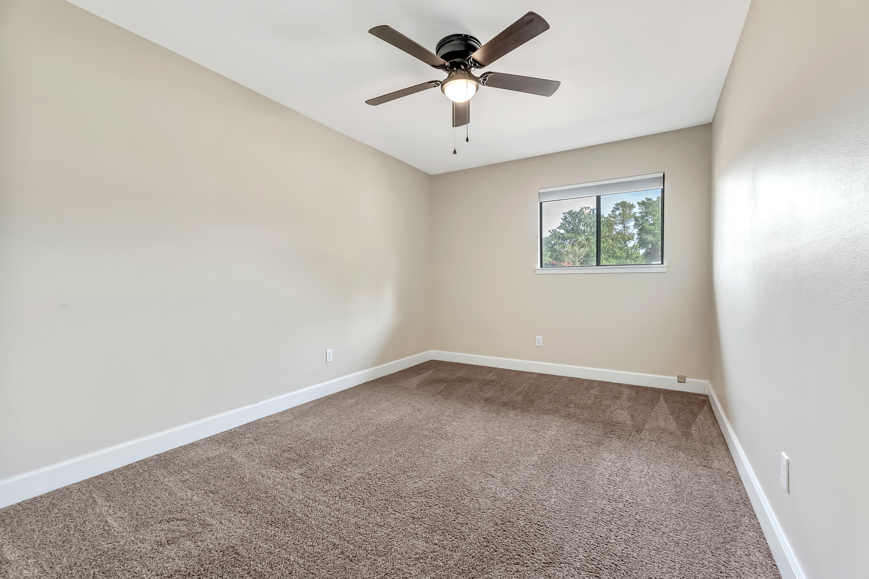 613 Caribbean Way Niceville, FL 32578 - Photo 10 of 27 an empty room with a window and a fan