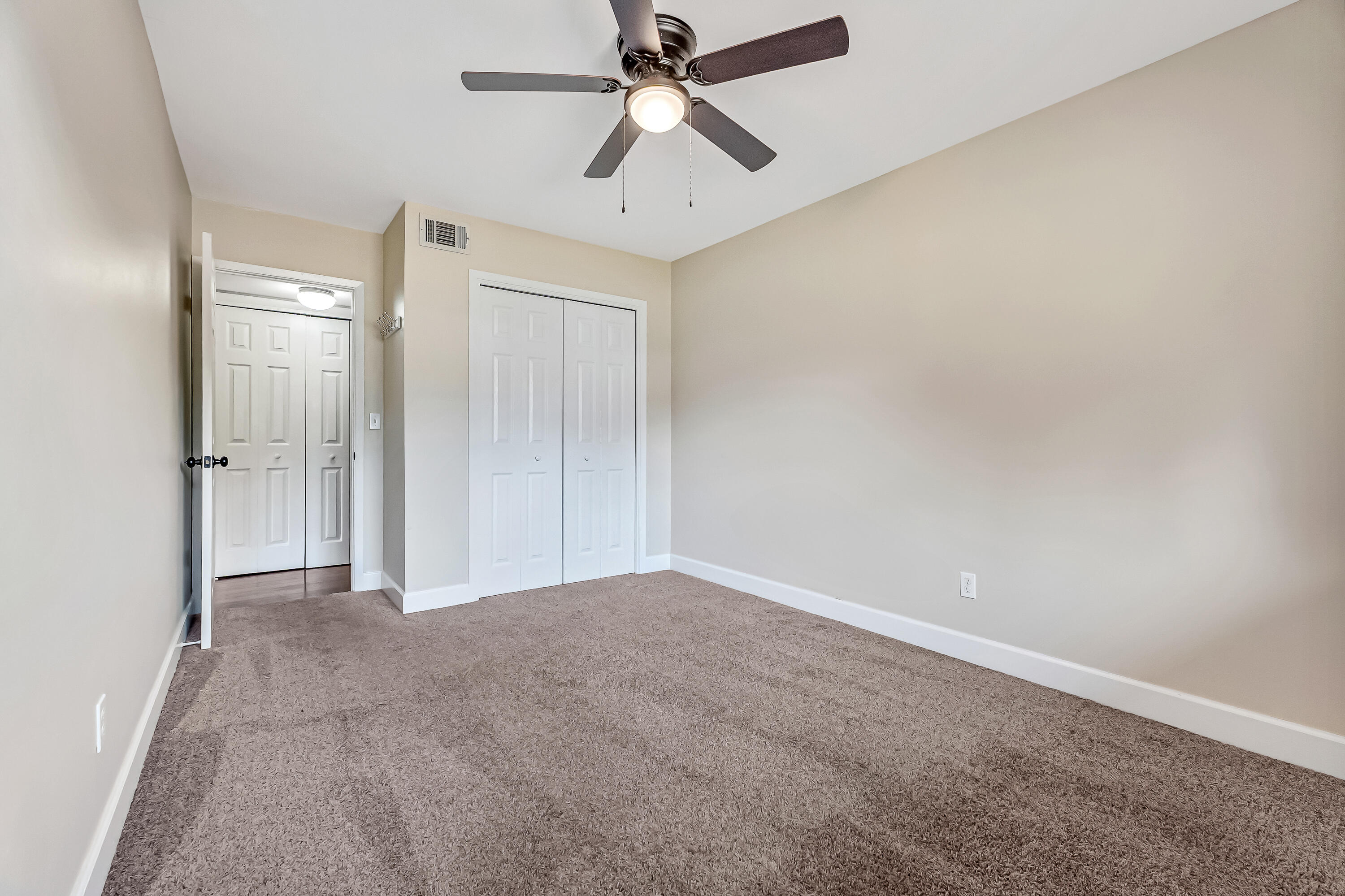 613 Caribbean Way Niceville, FL 32578 - Photo 11 of 27 an empty room with chandelier fan