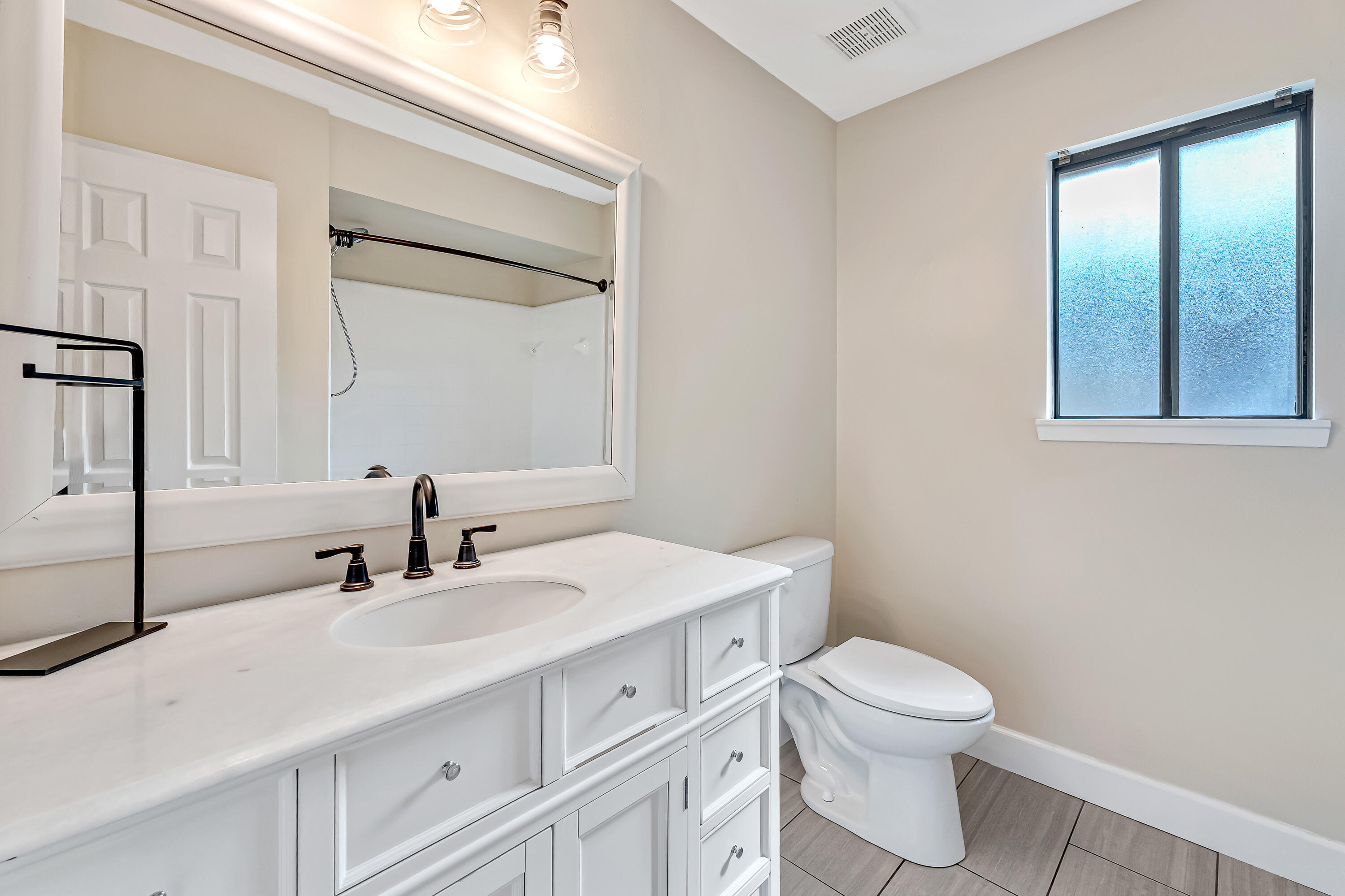 613 Caribbean Way Niceville, FL 32578 - Photo 14 of 27 a bathroom with a sink a toilet and mirror