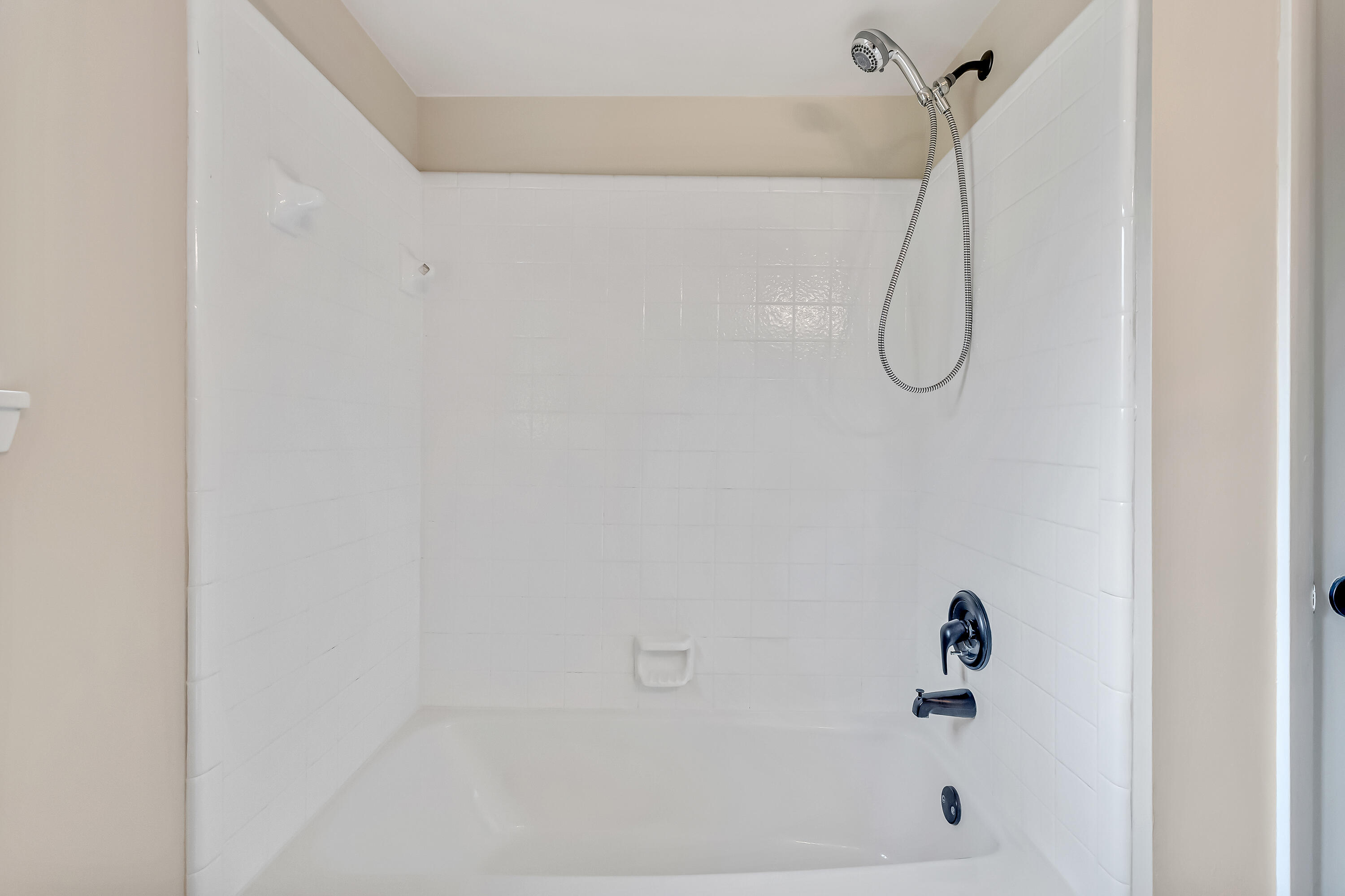 613 Caribbean Way Niceville, FL 32578 - Photo 16 of 27 a bathroom with a bath tub and a shower