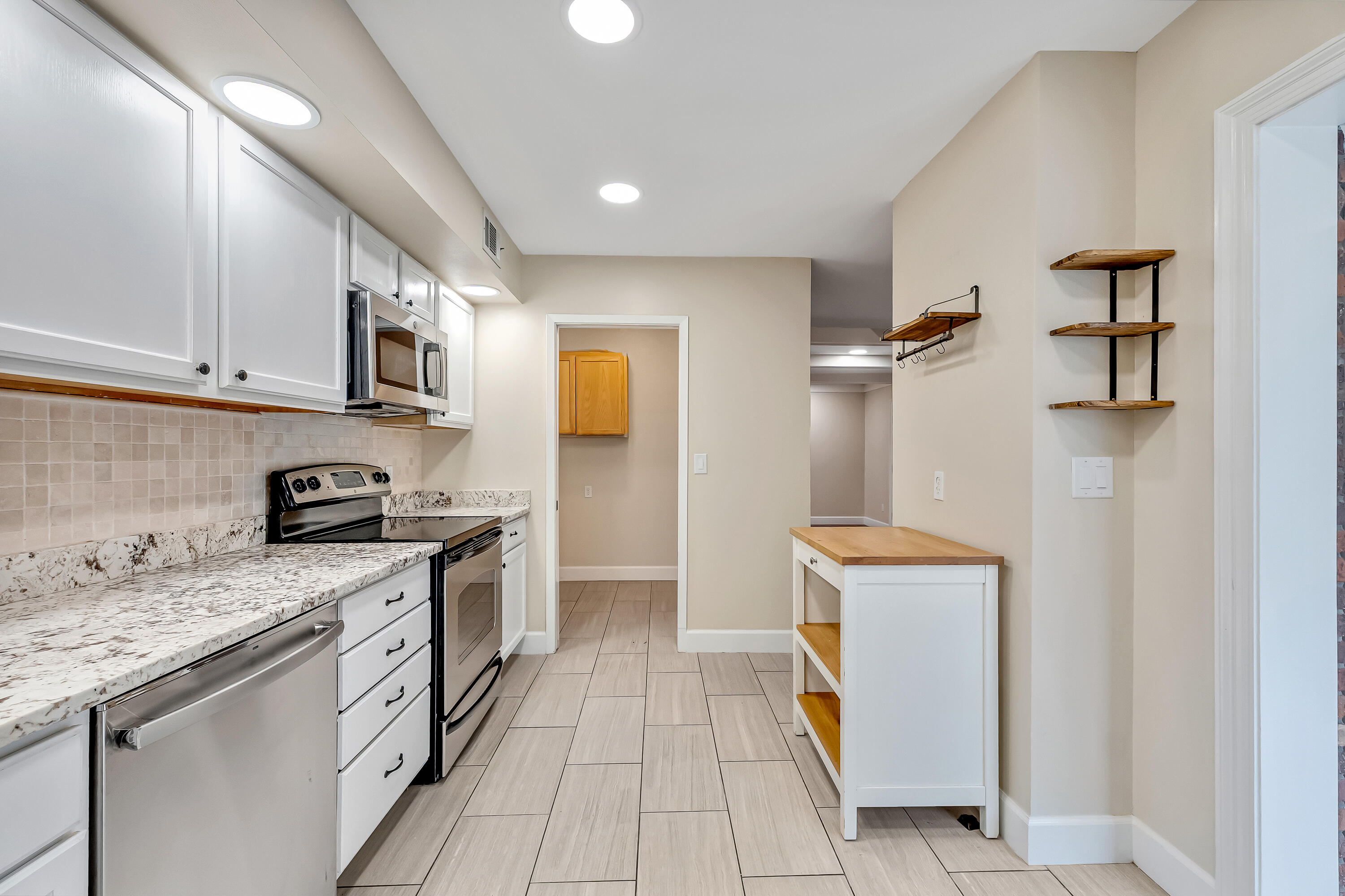 613 Caribbean Way Niceville, FL 32578 - Photo 18 of 27 a kitchen with stainless steel appliances granite countertop a stove a sink and a refrigerator