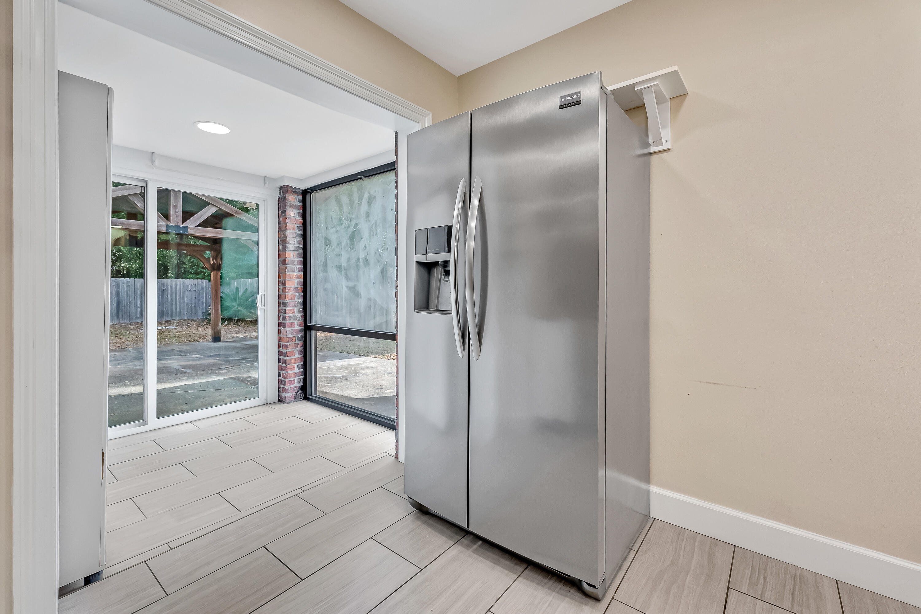 613 Caribbean Way Niceville, FL 32578 - Photo 19 of 27 a view of empty room with wooden floor and entryway