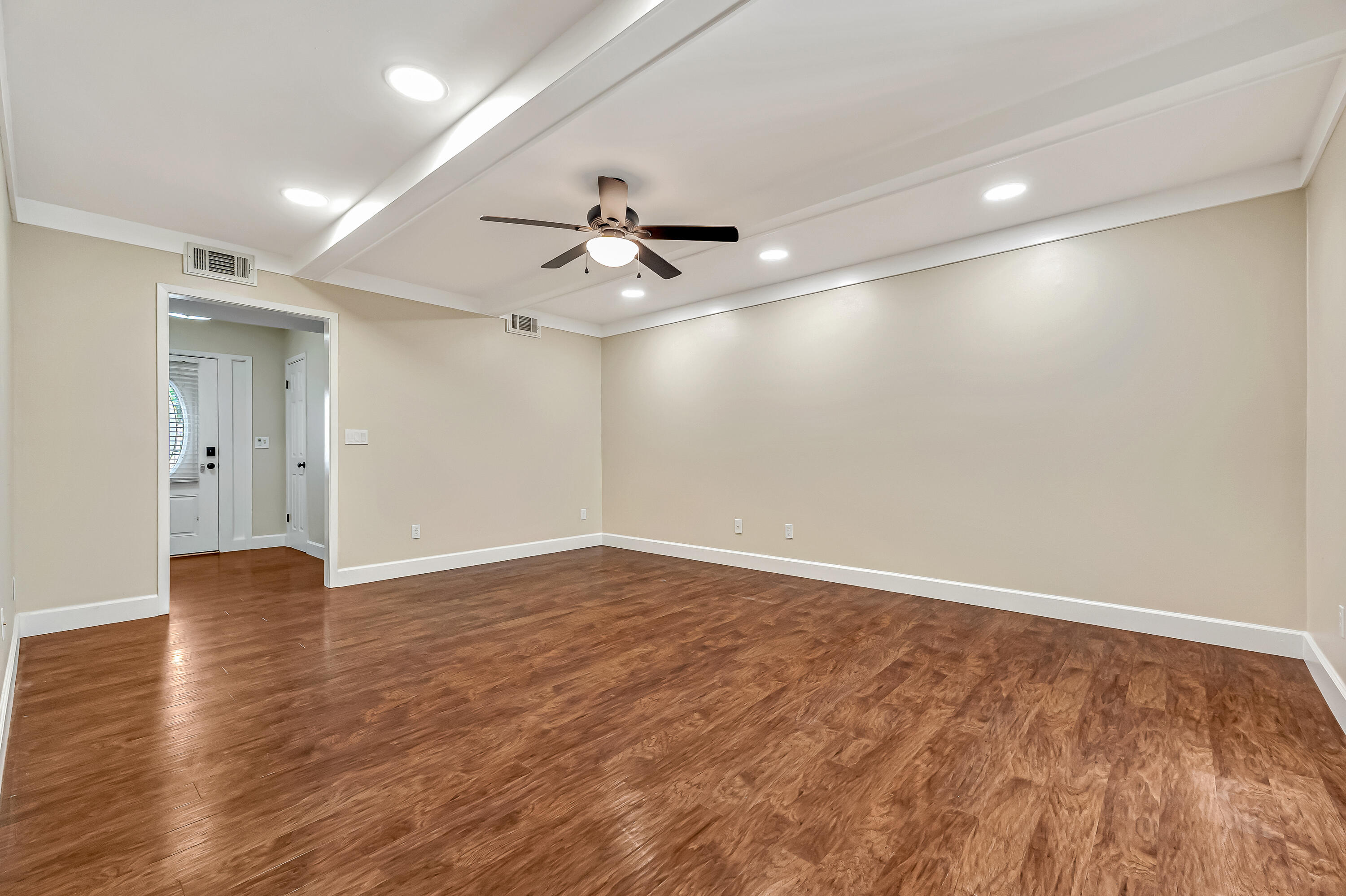 613 Caribbean Way Niceville, FL 32578 - Photo 2 of 27 a view of an empty room with wooden floor