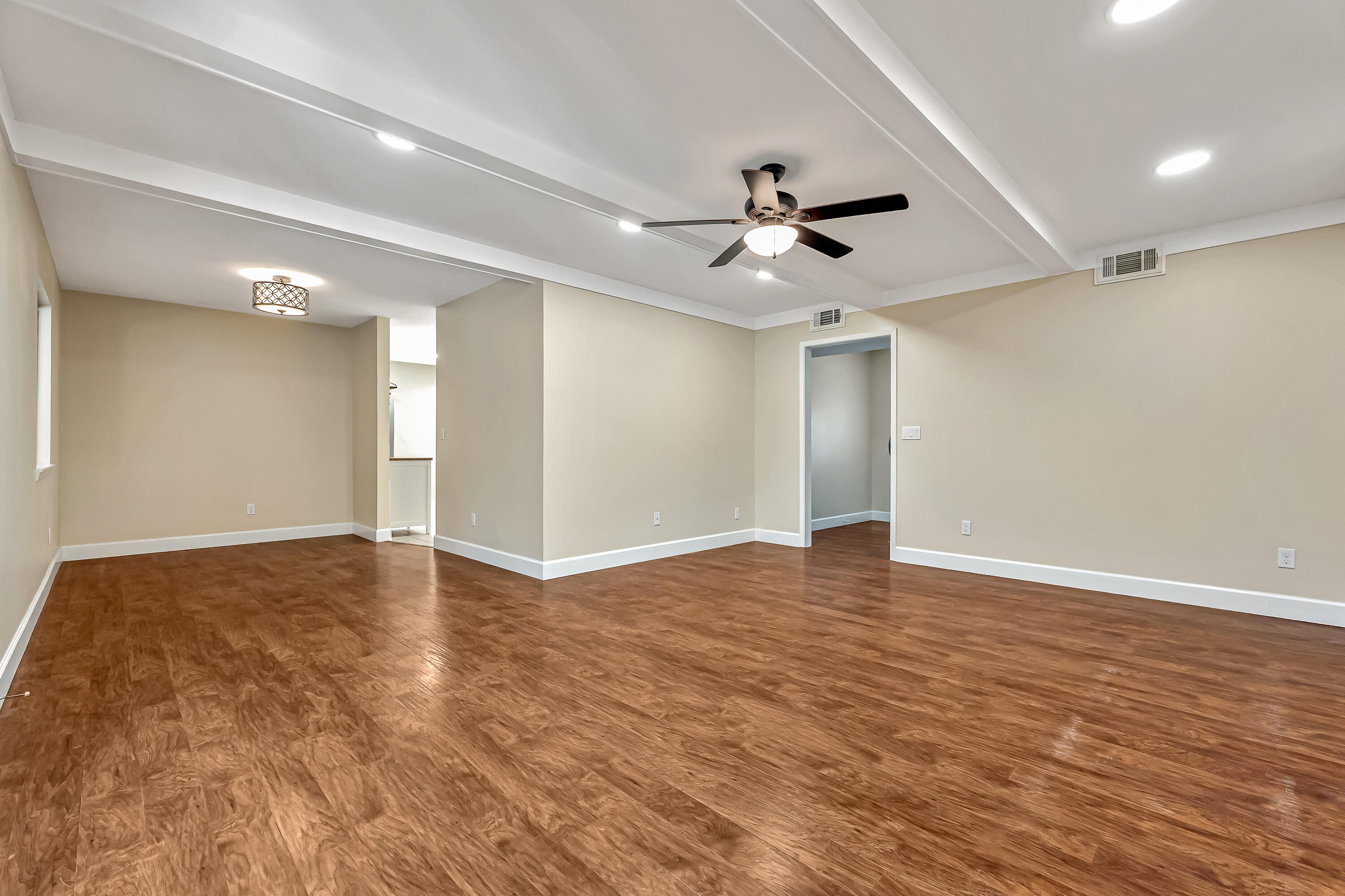 613 Caribbean Way Niceville, FL 32578 - Photo 4 of 27 a view of an empty room with a ceiling fan window and ceiling fan