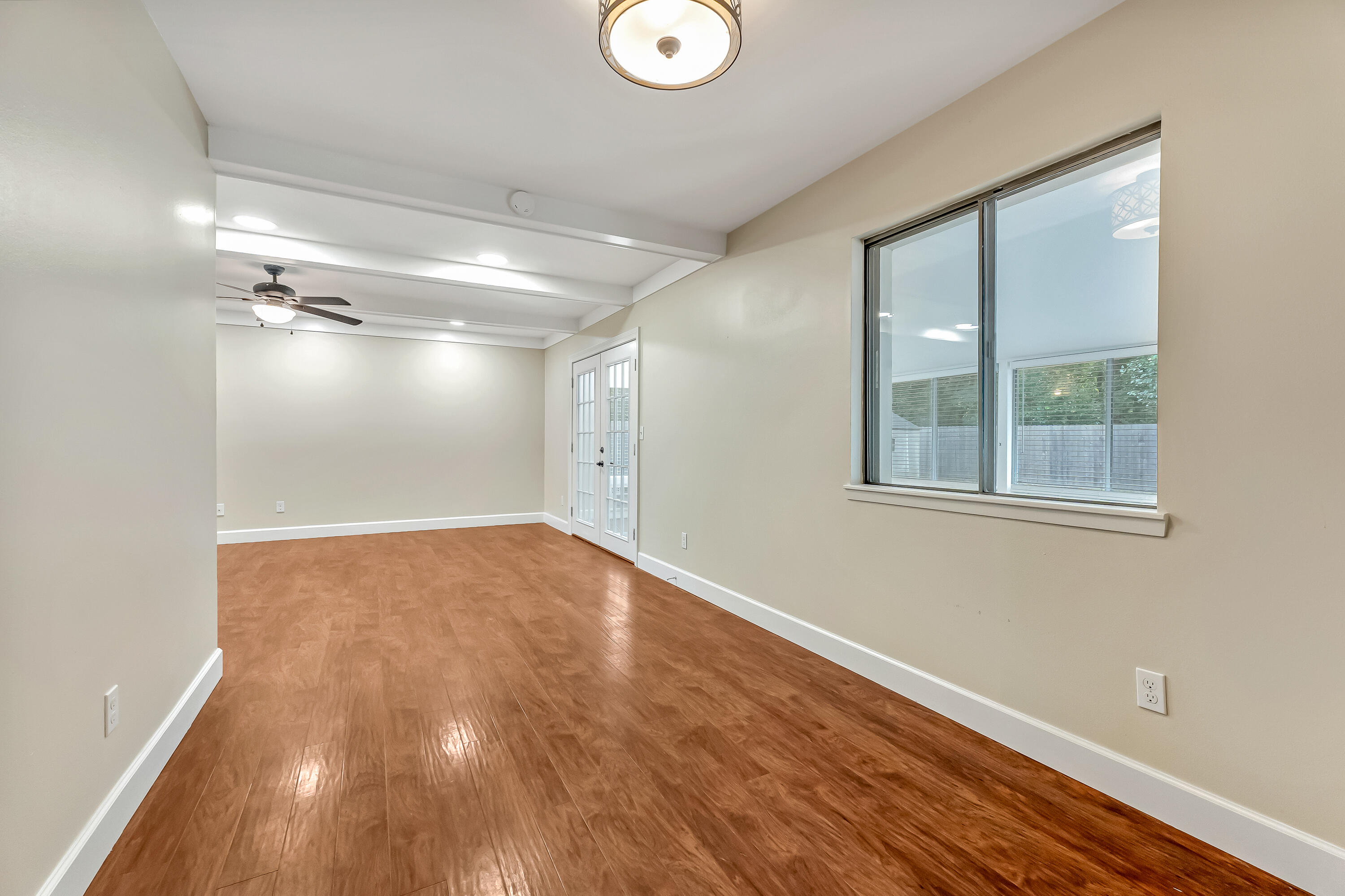 613 Caribbean Way Niceville, FL 32578 - Photo 5 of 27 a view of empty room with wooden floor and fan