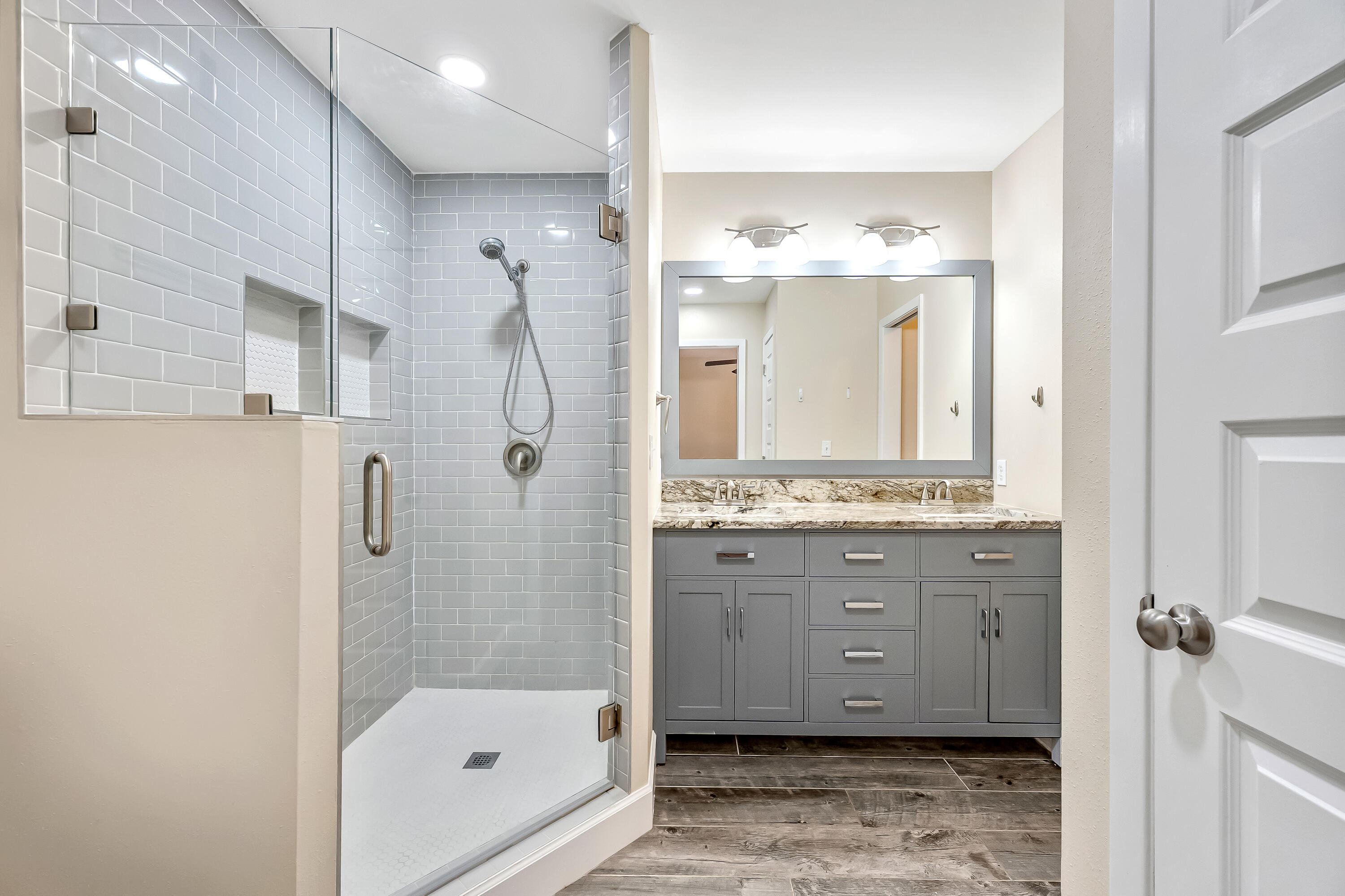 613 Caribbean Way Niceville, FL 32578 - Photo 8 of 27 a bathroom with a granite countertop sink mirror and shower