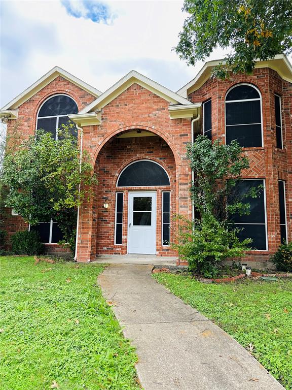 7310 Cedarbrook Road Rowlett, TX 75089 - Photo 1 of 1 a front view of a house with a yard and garage