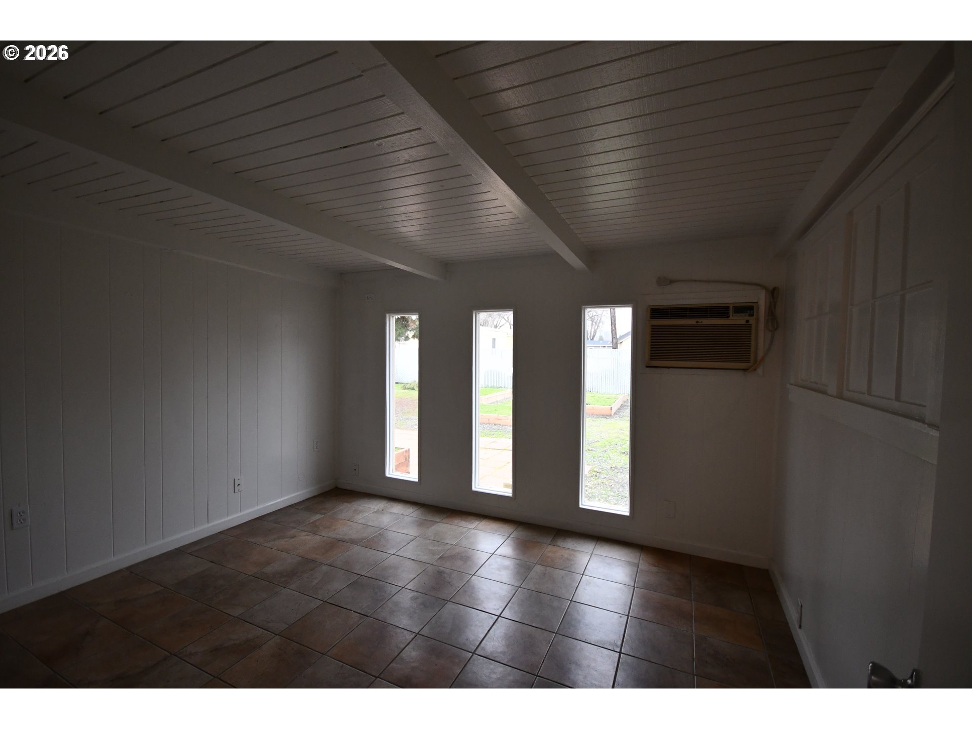 918 Snipes Street The Dalles, OR 97058 - Photo 19 of 47 a view of an empty room with wooden floor and windows