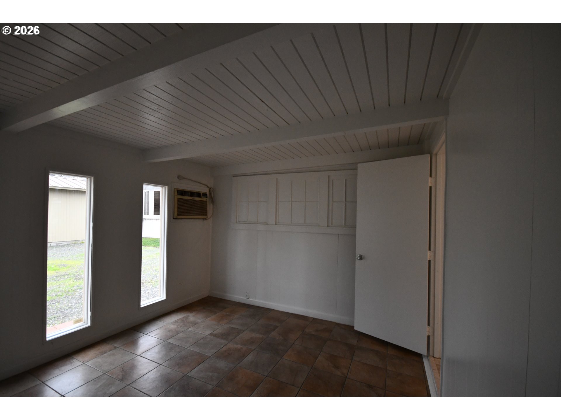 918 Snipes Street The Dalles, OR 97058 - Photo 20 of 47 a view of an empty room with wooden floor and a window