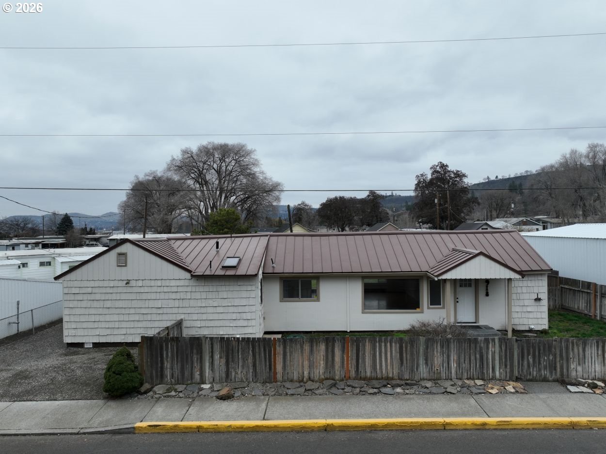 918 Snipes Street The Dalles, OR 97058 - Photo 2 of 47 a view of a house with wooden deck