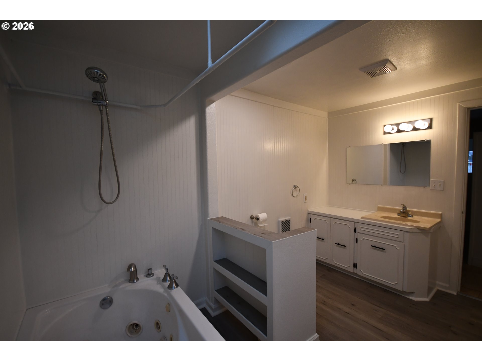 918 Snipes Street The Dalles, OR 97058 - Photo 29 of 47 a bathroom with a double vanity sink a mirror and a bathtub