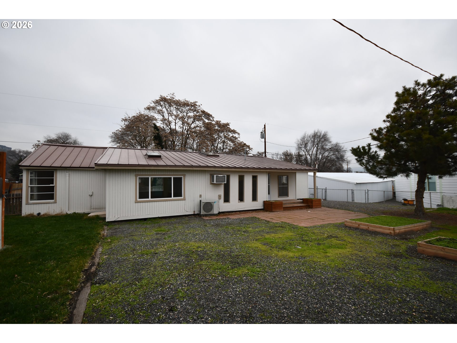 918 Snipes Street The Dalles, OR 97058 - Photo 41 of 47 a view of a yard in front of a house with large trees
