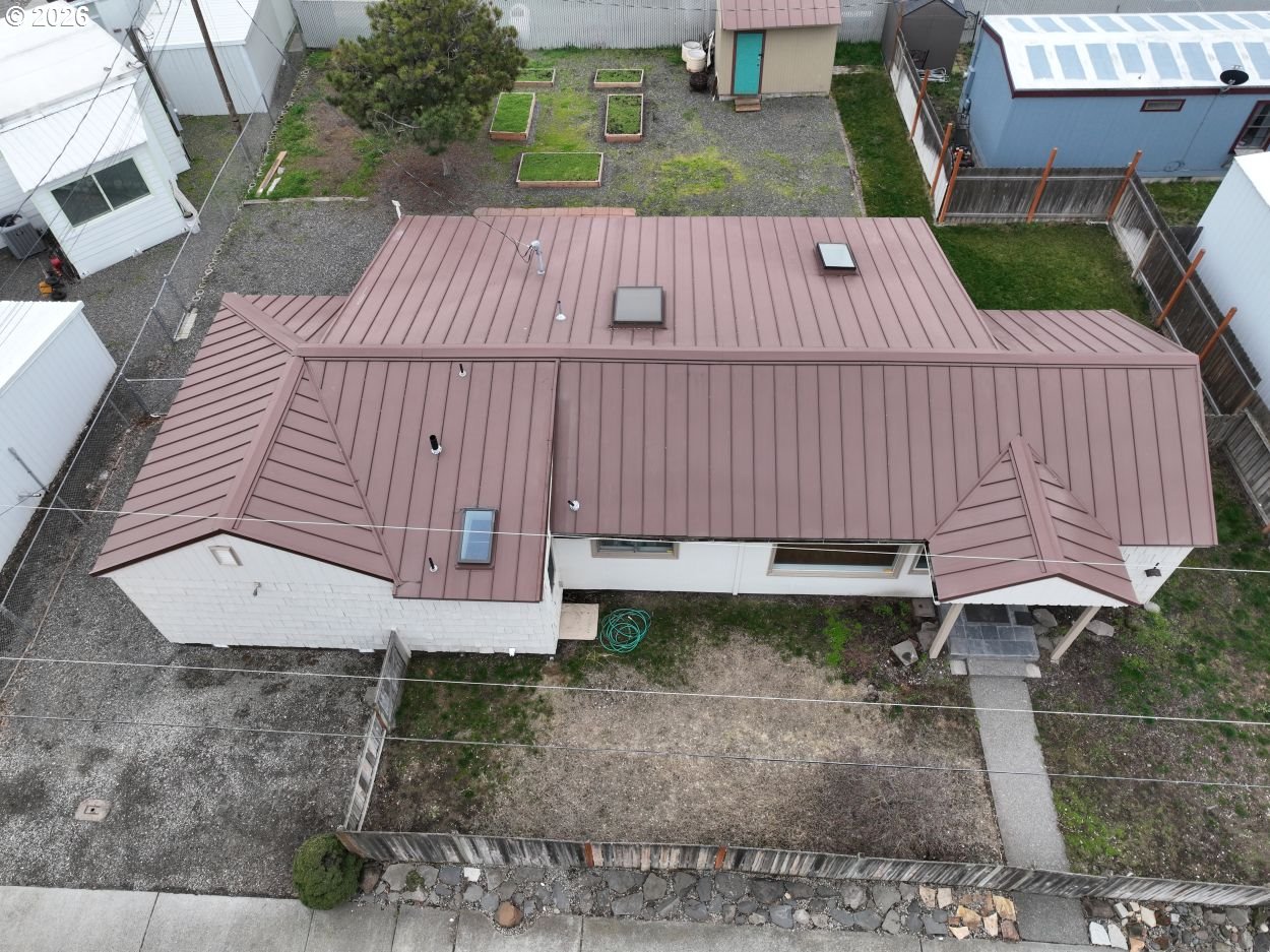 918 Snipes Street The Dalles, OR 97058 - Photo 43 of 47 a view of a backyard with a deck and a garden