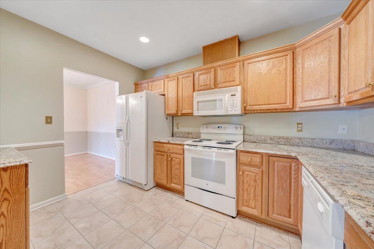 4448 Pheasant Ridge Road, Unit 307 Roanoke, VA 24014 - Photo 12 of 30 a kitchen with granite countertop a sink stove and refrigerator