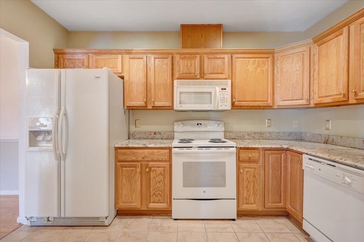4448 Pheasant Ridge Road, Unit 307 Roanoke, VA 24014 - Photo 14 of 30 a kitchen with stainless steel appliances granite countertop a refrigerator sink and stove