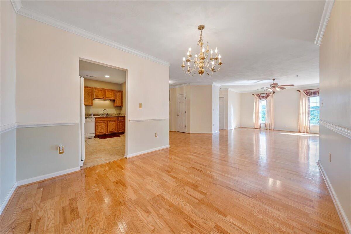 4448 Pheasant Ridge Road, Unit 307 Roanoke, VA 24014 - Photo 15 of 30 a view of a hallway with wooden floor and chandelier