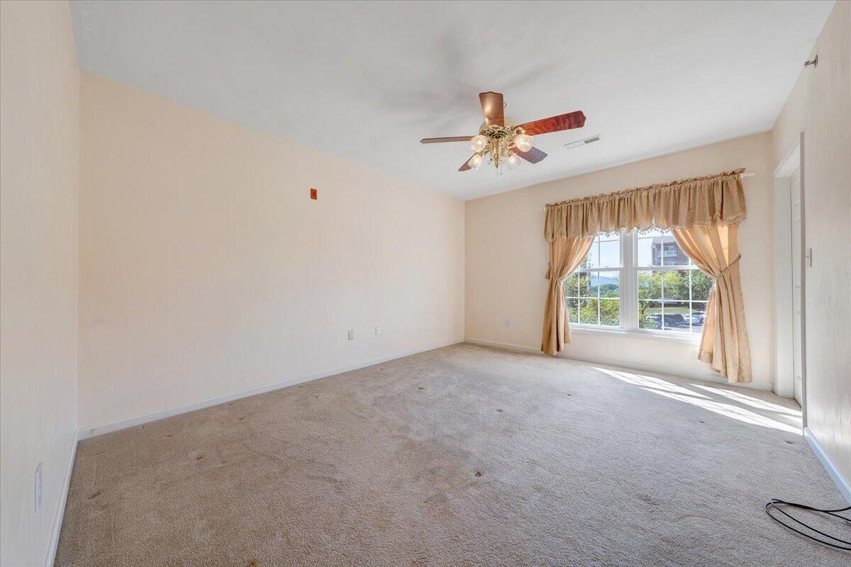4448 Pheasant Ridge Road, Unit 307 Roanoke, VA 24014 - Photo 19 of 30 a view of a livingroom with a ceiling fan and window