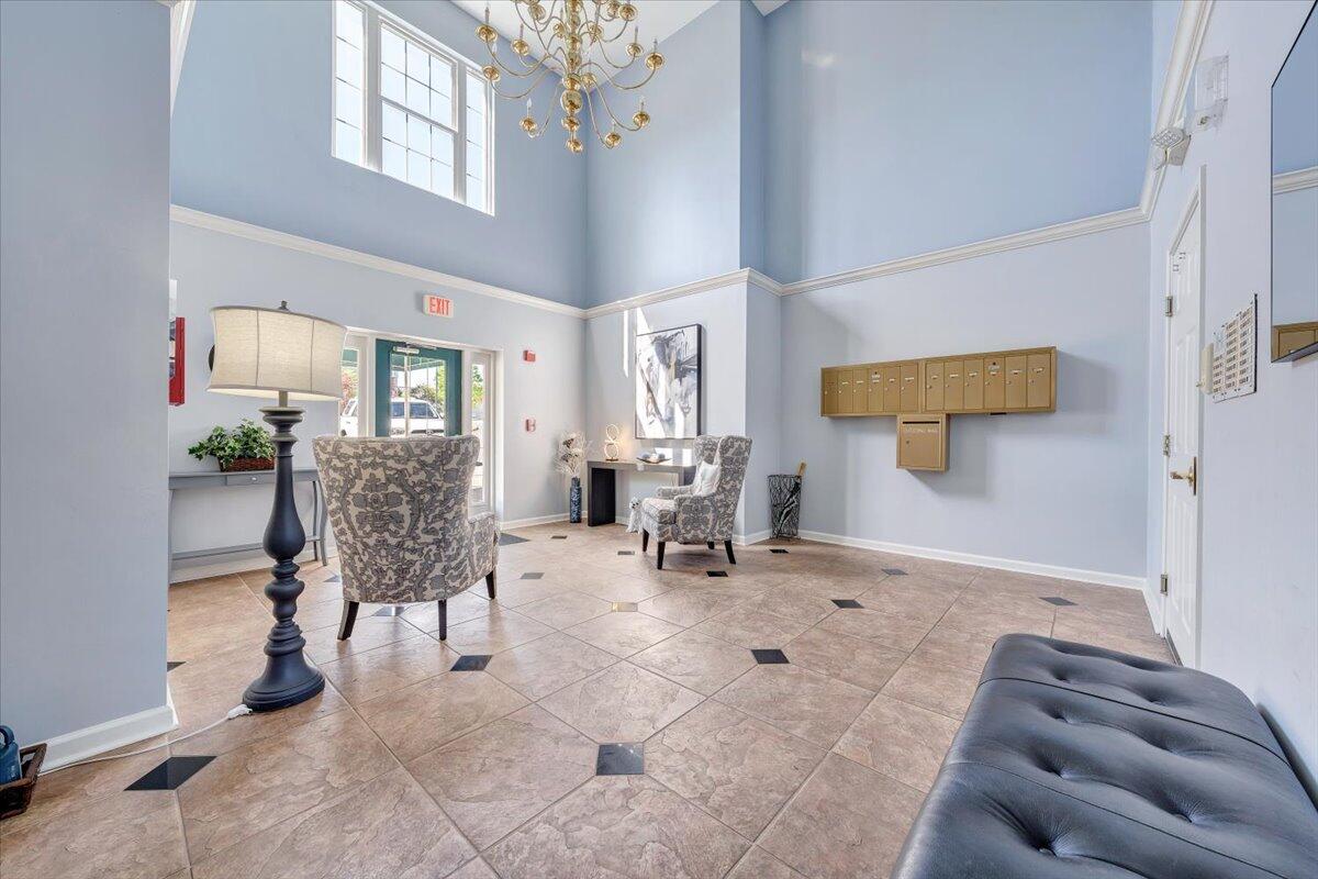 4448 Pheasant Ridge Road, Unit 307 Roanoke, VA 24014 - Photo 28 of 30 a living room with furniture and a chandelier
