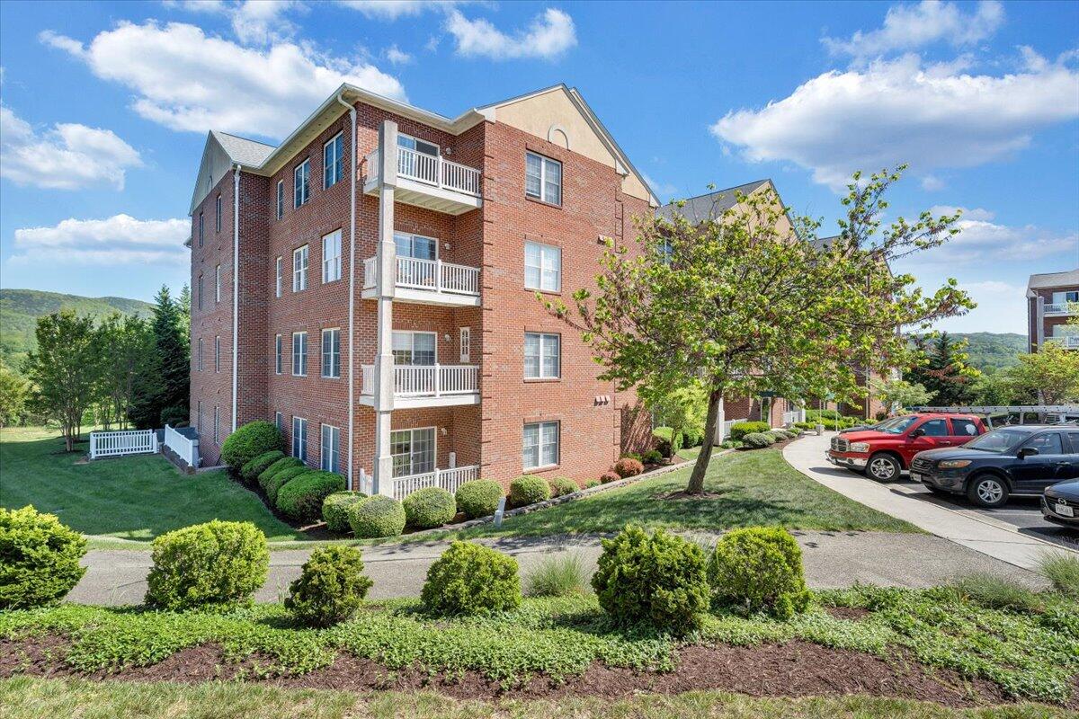 4448 Pheasant Ridge Road, Unit 307 Roanoke, VA 24014 - Photo 3 of 30 a front view of a residential apartment building with a yard