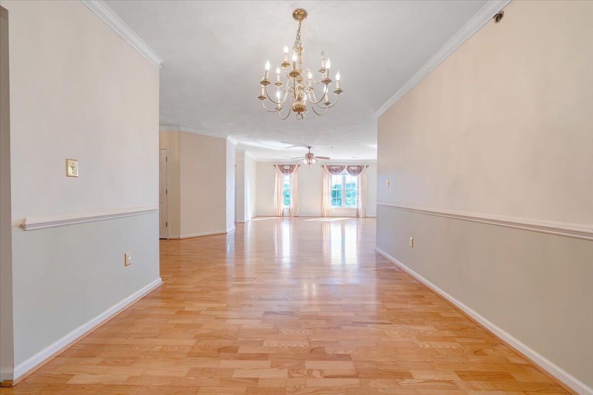 4448 Pheasant Ridge Road, Unit 307 Roanoke, VA 24014 - Photo 5 of 30 a view of an empty room with chandelier and wooden floor