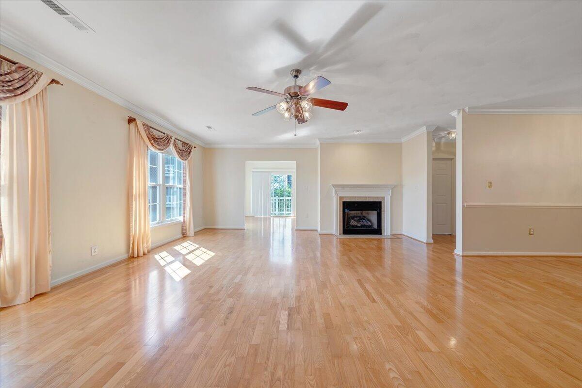 4448 Pheasant Ridge Road, Unit 307 Roanoke, VA 24014 - Photo 6 of 30 an empty room with wooden floor fireplace and windows