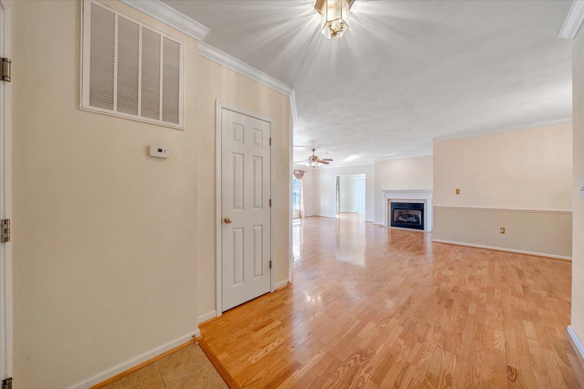 4448 Pheasant Ridge Road, Unit 307 Roanoke, VA 24014 - Photo 7 of 30 a view of an empty room with chandelier fan and fire place