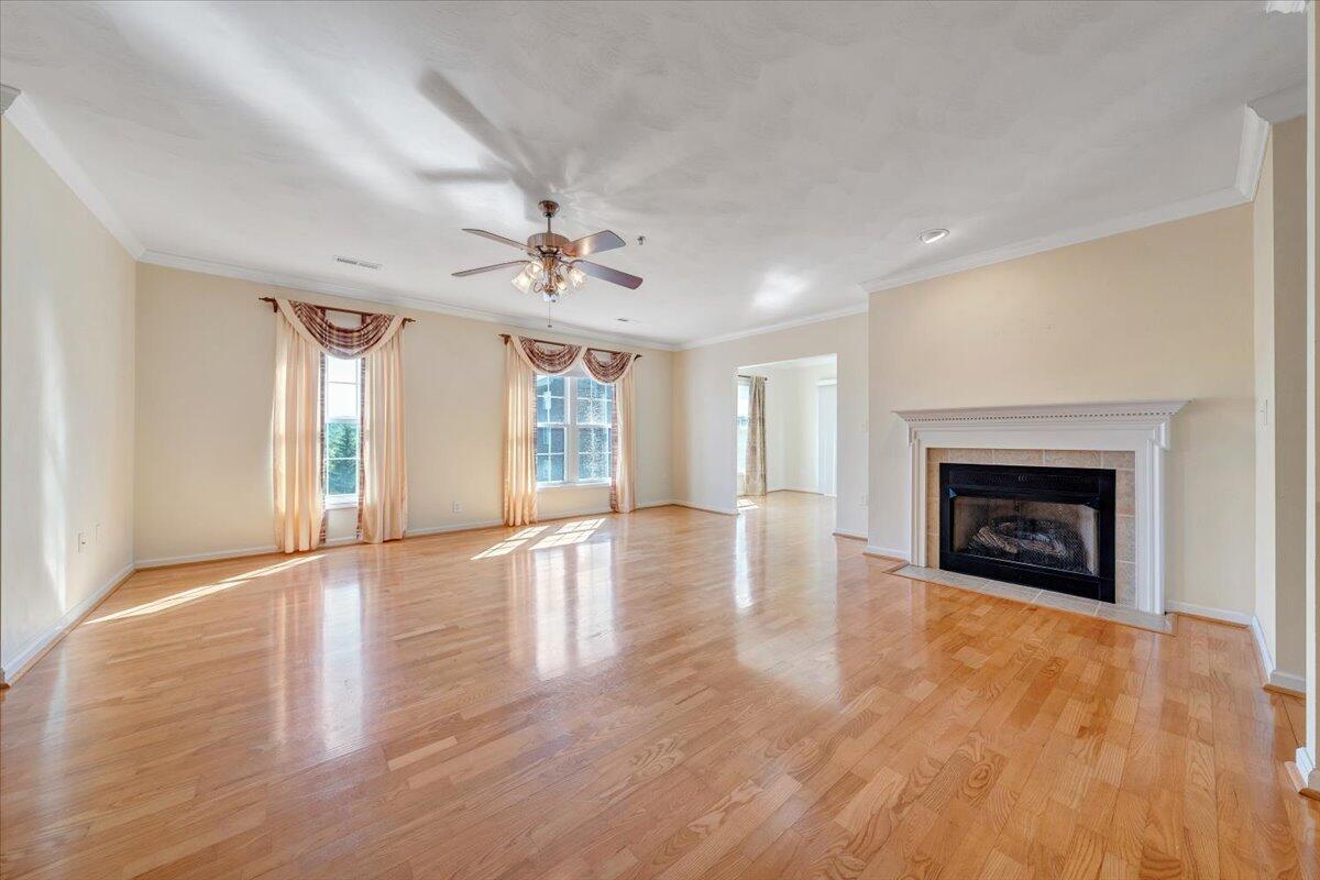4448 Pheasant Ridge Road, Unit 307 Roanoke, VA 24014 - Photo 9 of 30 a view of an empty room with wooden floor fireplace and a window