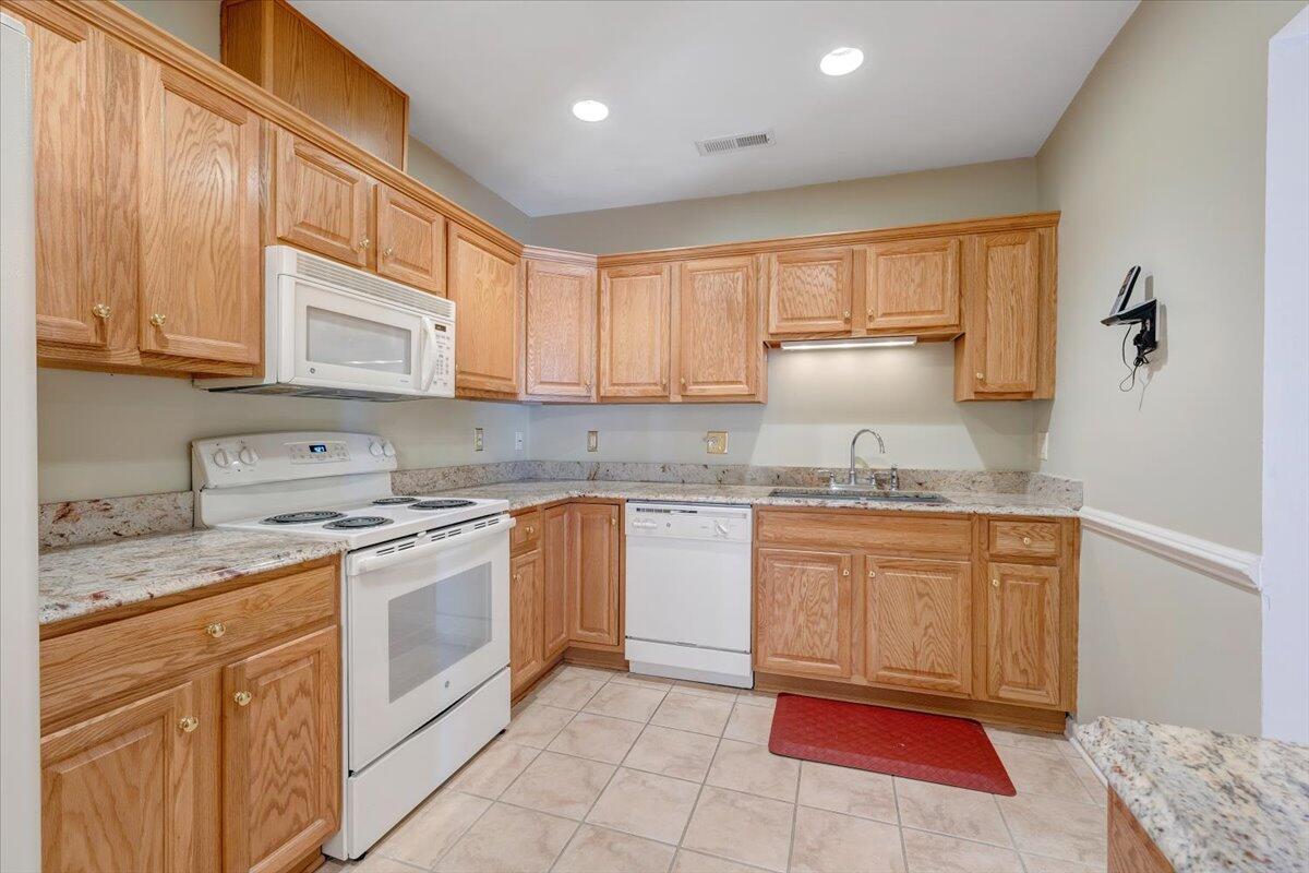 4448 Pheasant Ridge Road, Unit 307 Roanoke, VA 24014 - Photo 10 of 30 a kitchen with granite countertop cabinets sink and stainless steel appliances
