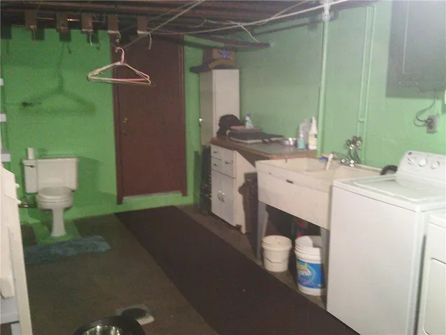 a bathroom with a sink toilet and a mirror