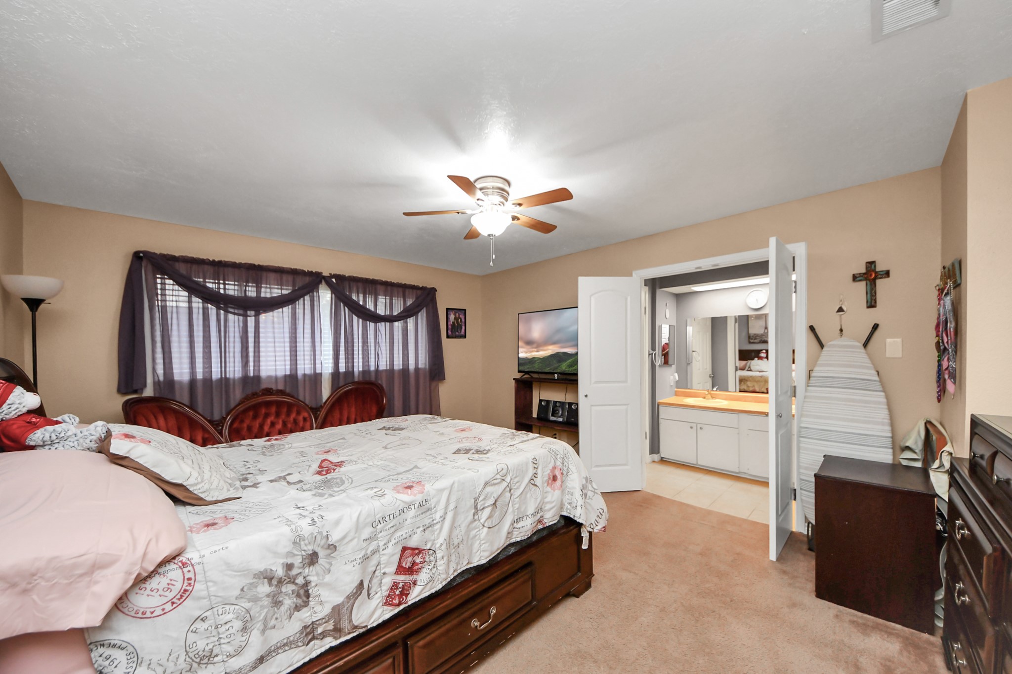 23127 Harpergate Drive Spring, TX 77373 - Photo 18 of 43 a bedroom with a bed and a chandelier