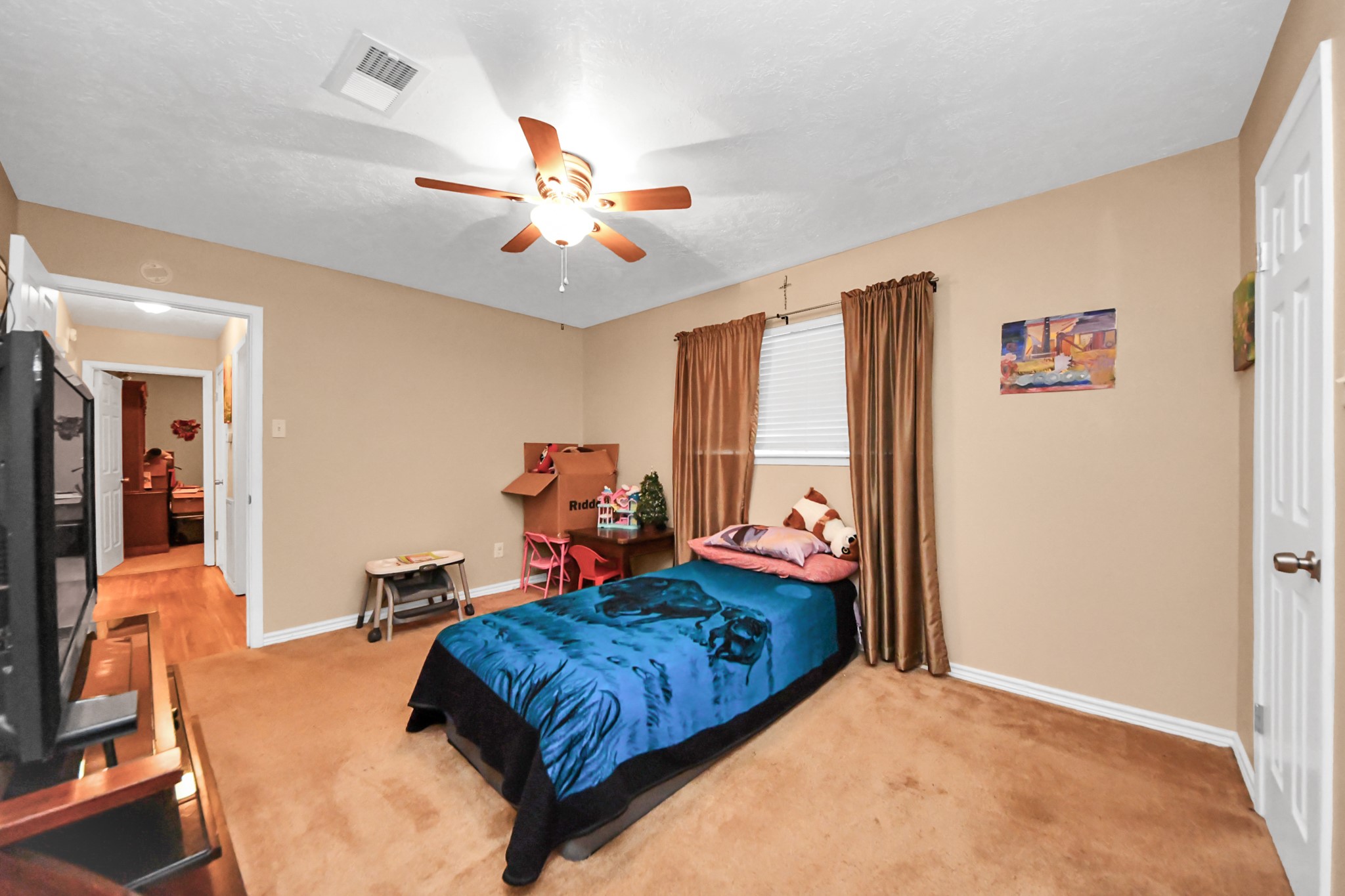 23127 Harpergate Drive Spring, TX 77373 - Photo 27 of 43 a bedroom with a bed and wooden floor
