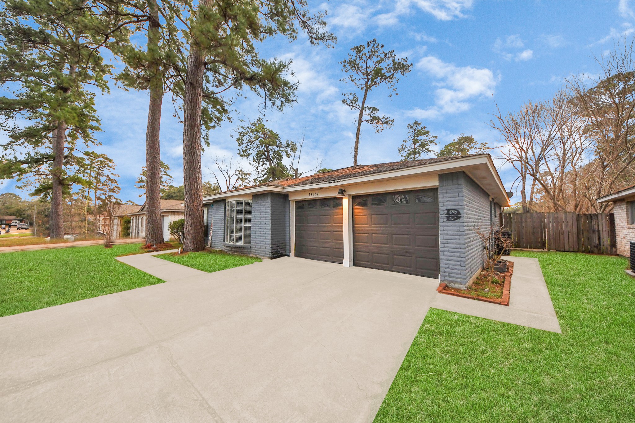 23127 Harpergate Drive Spring, TX 77373 - Photo 40 of 43 a front view of a house with a yard and trees