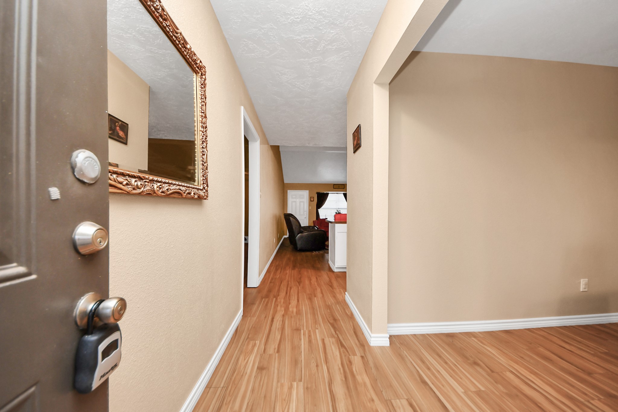 23127 Harpergate Drive Spring, TX 77373 - Photo 4 of 43 a view of a hallway with wooden floor and furniture