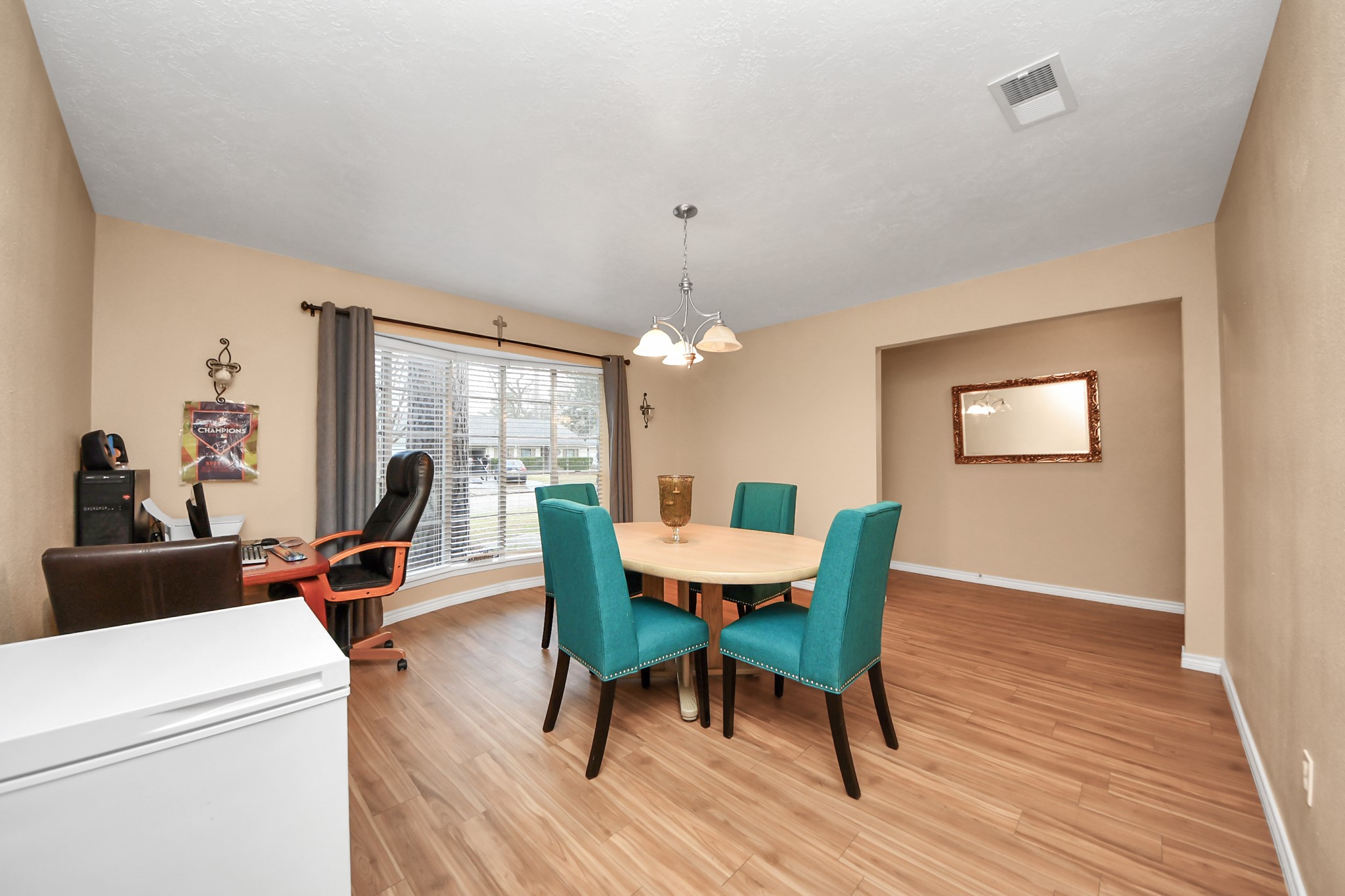 23127 Harpergate Drive Spring, TX 77373 - Photo 5 of 43 a dining room with furniture a chandelier and wooden floor