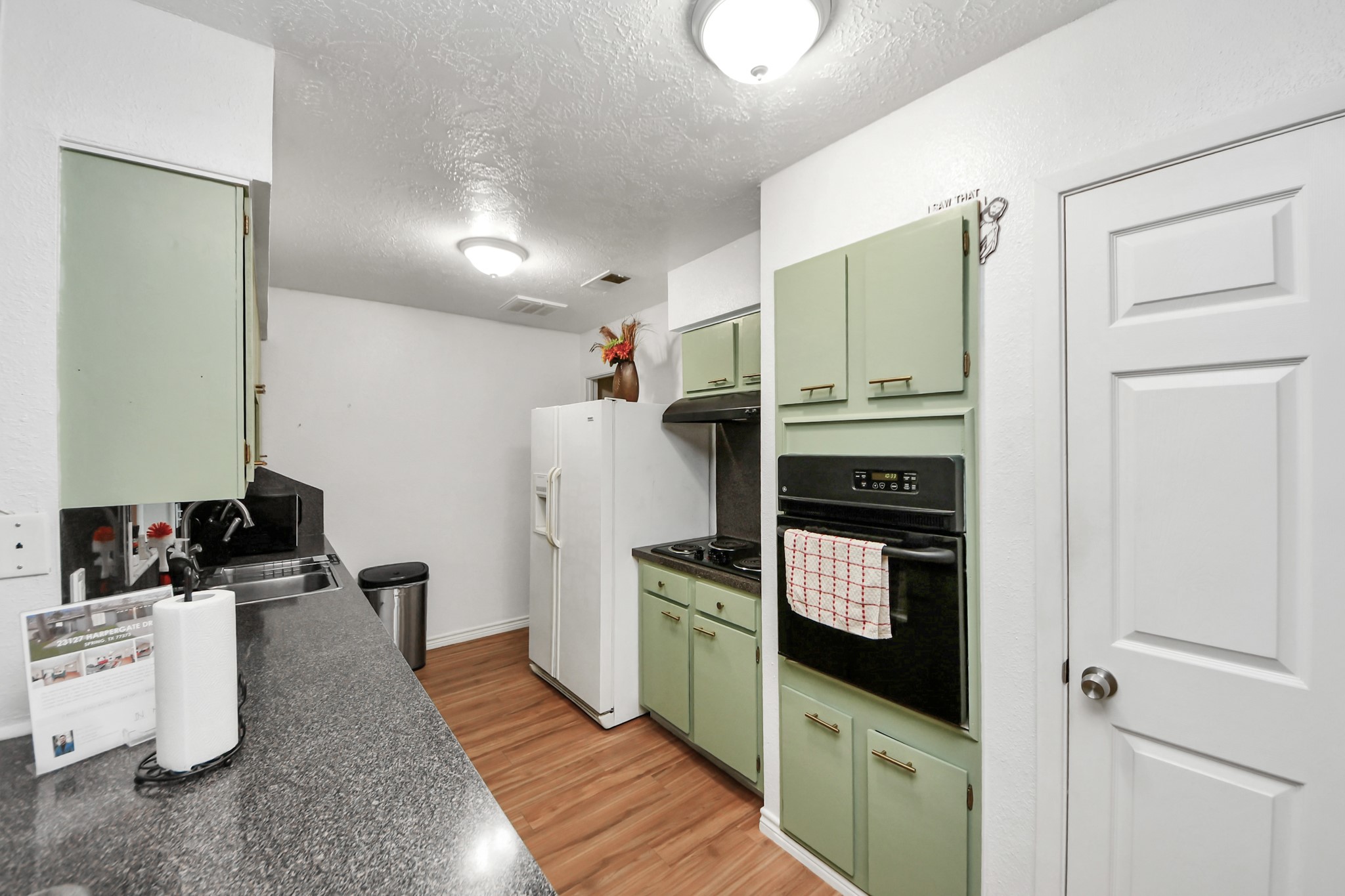 23127 Harpergate Drive Spring, TX 77373 - Photo 7 of 43 a kitchen with a refrigerator and a stove