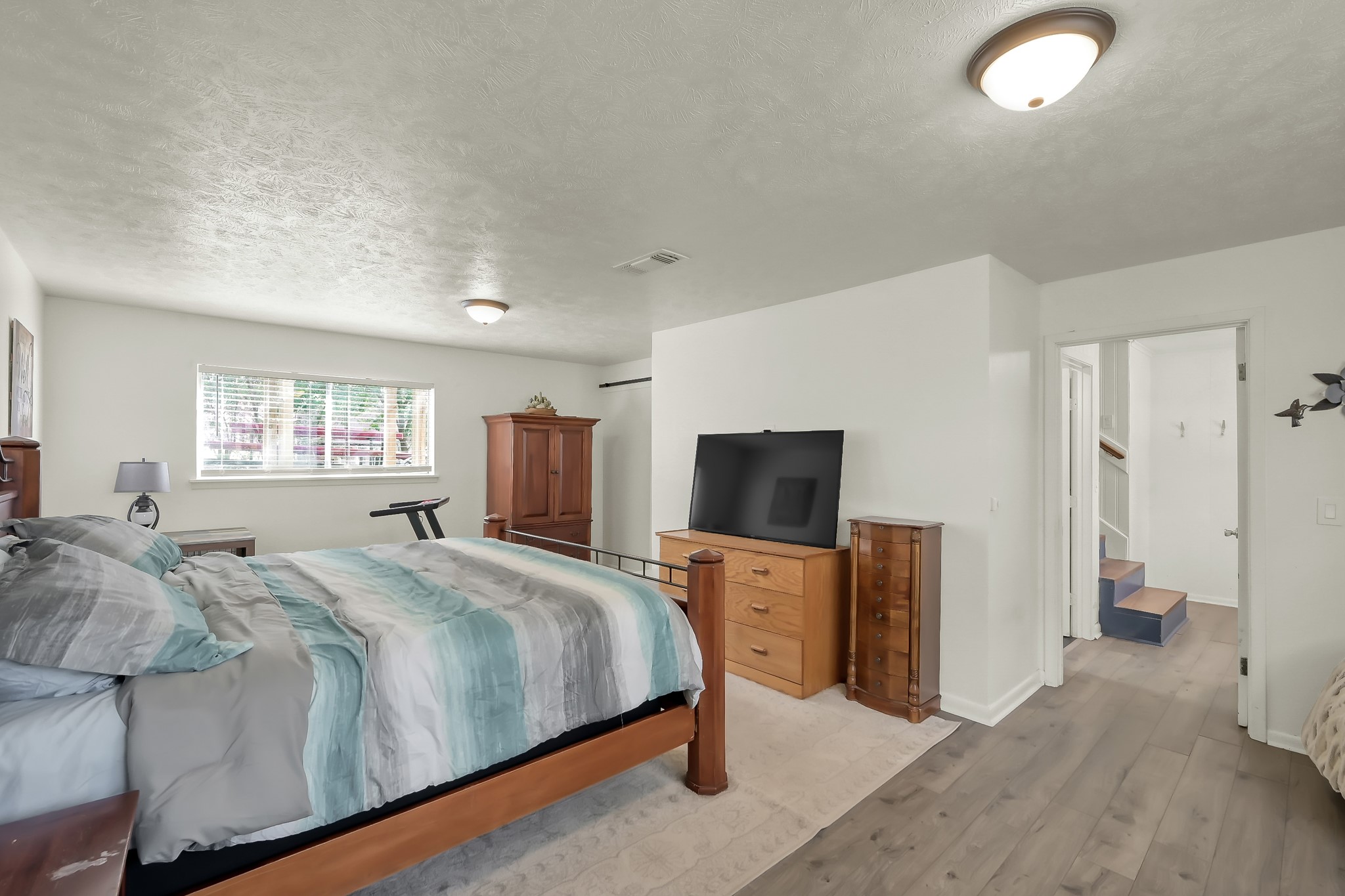 329 Sassafras Drive Trinity, TX 75862 - Photo 29 of 48 a bedroom with a bed and a flat tv screen on dresser