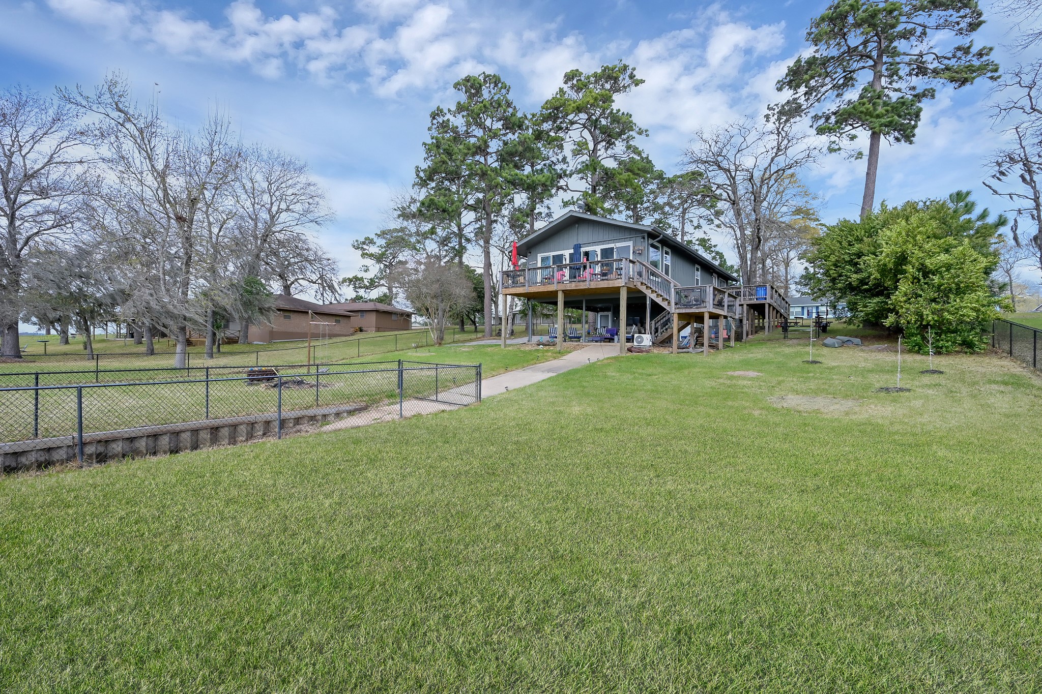 329 Sassafras Drive Trinity, TX 75862 - Photo 44 of 48 a view of a house next to a big yard and large trees