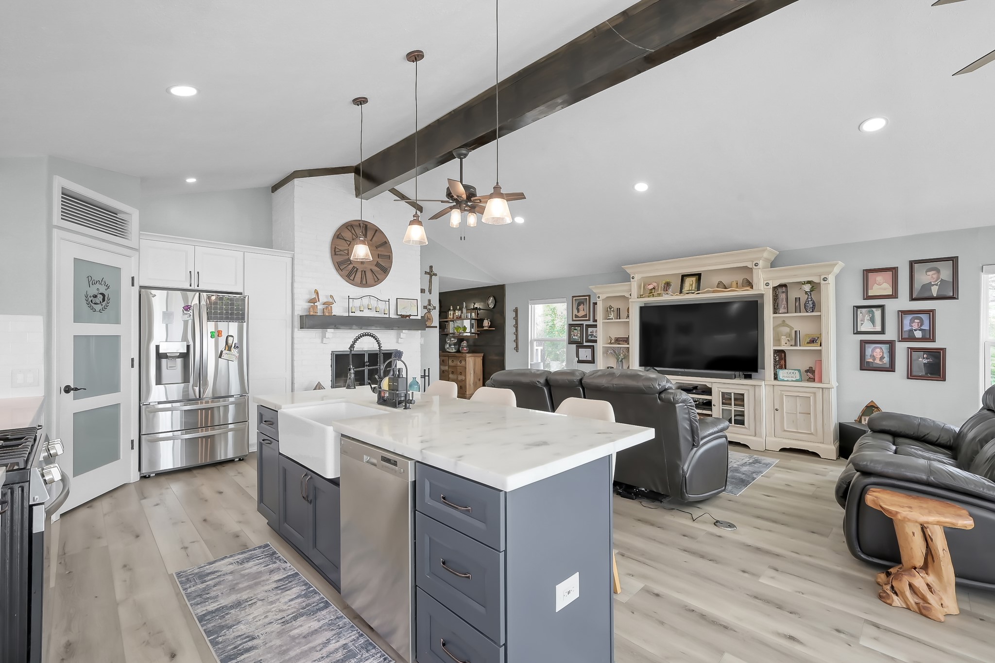329 Sassafras Drive Trinity, TX 75862 - Photo 9 of 48 a large living room with stainless steel appliances kitchen island granite countertop a table chairs and a flat screen tv