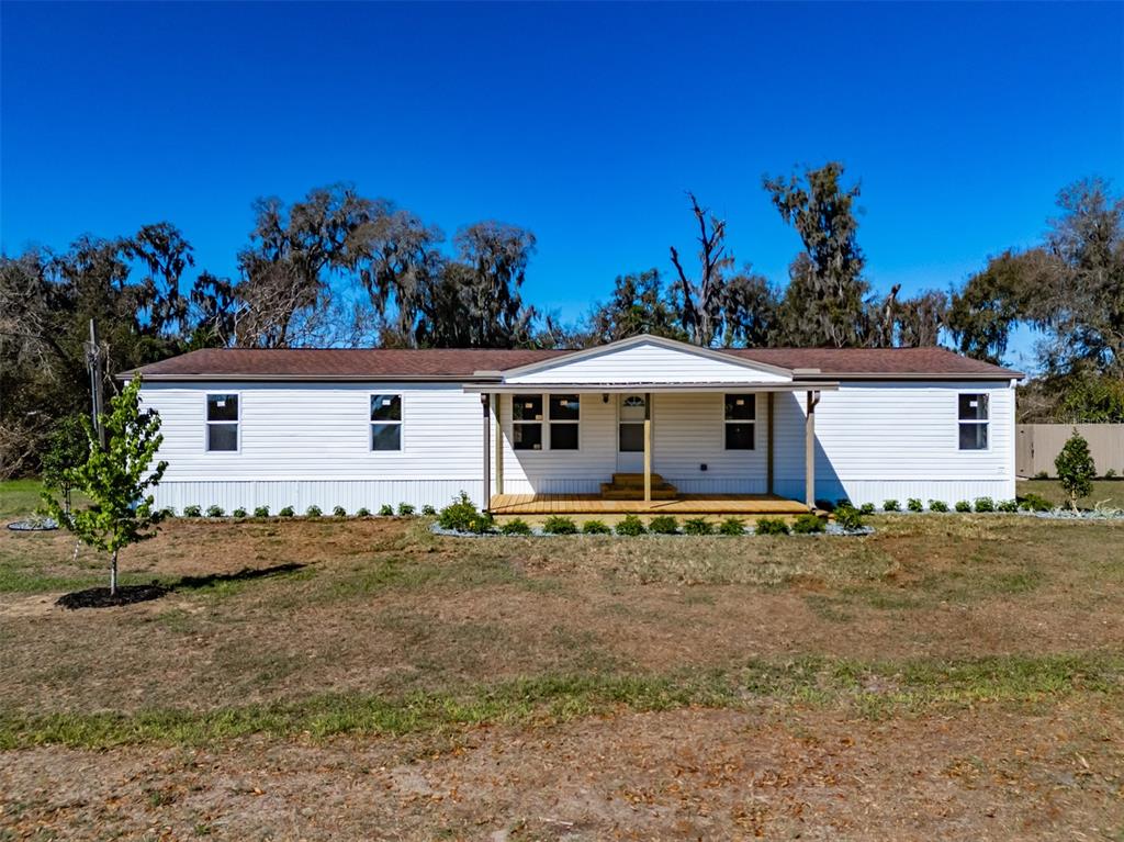 a view of a house with a backyard