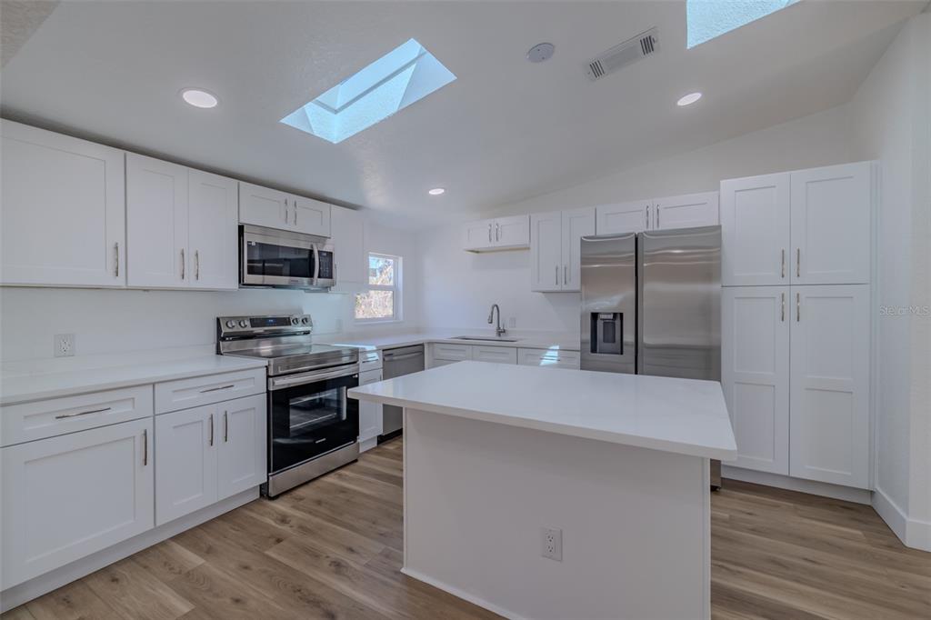 8301 Henry George Road Plant City, FL 33567 - Photo 13 of 51 a large kitchen with cabinets stainless steel appliances and a counter space