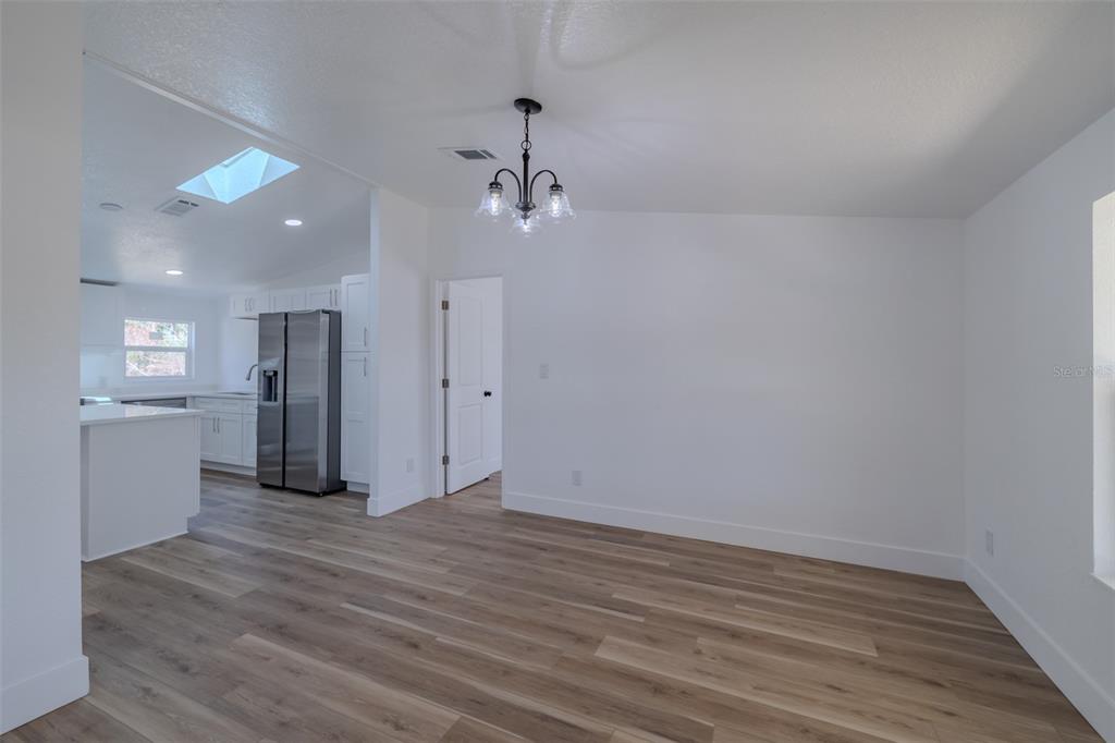 8301 Henry George Road Plant City, FL 33567 - Photo 18 of 51 a view of a kitchen with a refrigerator and a stove top oven