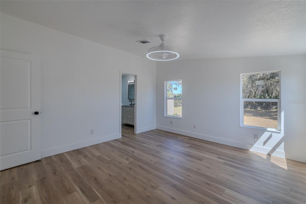 8301 Henry George Road Plant City, FL 33567 - Photo 20 of 51 a view of an empty room with a window and wooden floor