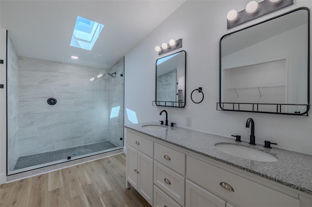 8301 Henry George Road Plant City, FL 33567 - Photo 22 of 51 a bathroom with double sink and a mirror