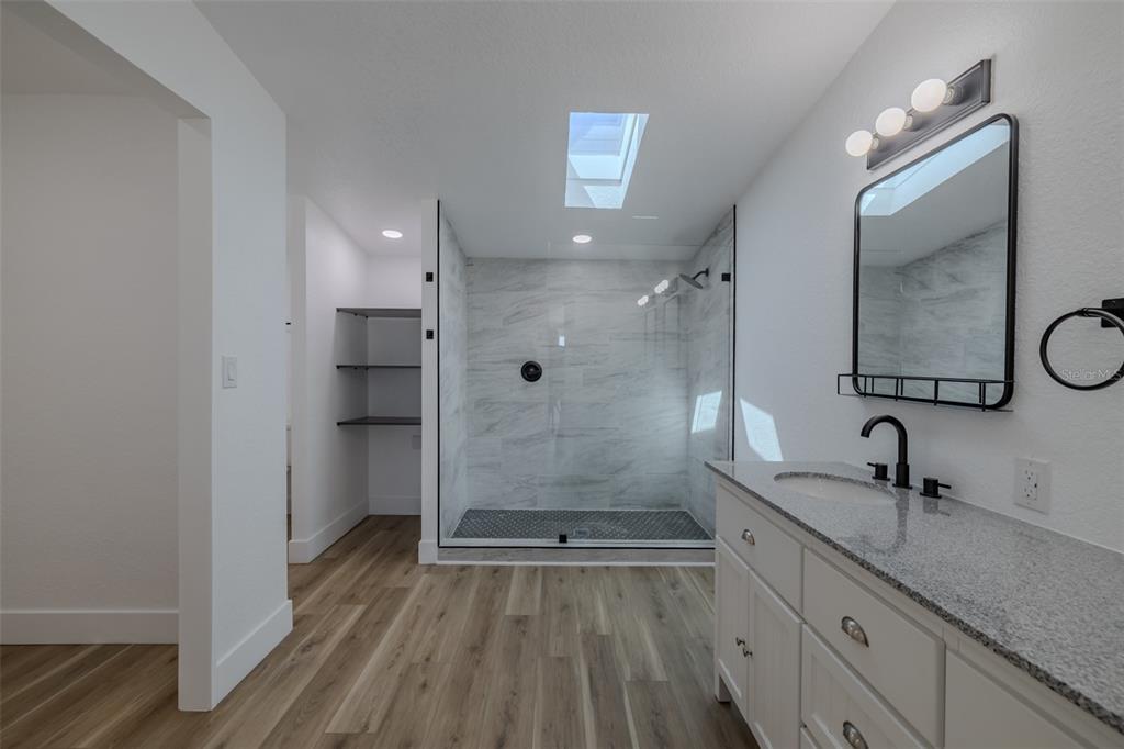 8301 Henry George Road Plant City, FL 33567 - Photo 23 of 51 a bathroom with a double vanity sink mirror and shower