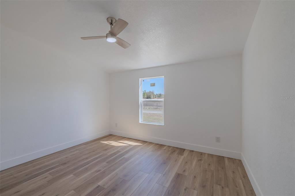 8301 Henry George Road Plant City, FL 33567 - Photo 28 of 51 wooden floor in an empty room with a window