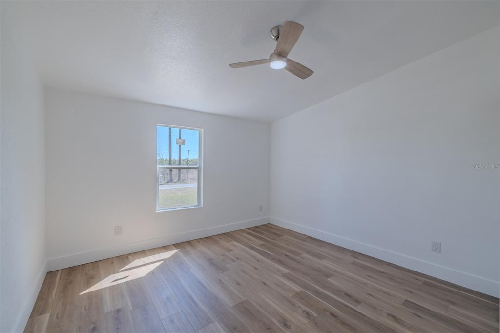 8301 Henry George Road Plant City, FL 33567 - Photo 32 of 51 wooden floor in an empty room with a window