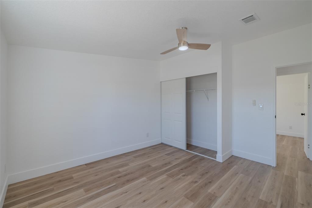 8301 Henry George Road Plant City, FL 33567 - Photo 33 of 51 a view of an empty room with wooden floor