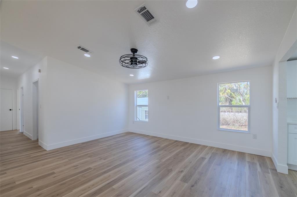 8301 Henry George Road Plant City, FL 33567 - Photo 36 of 51 a view of an empty room and a window and wooden floor
