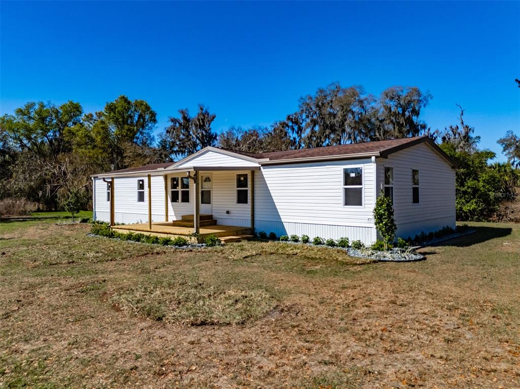 8301 Henry George Road Plant City, FL 33567 - Photo 37 of 51 a view of a house with a yard