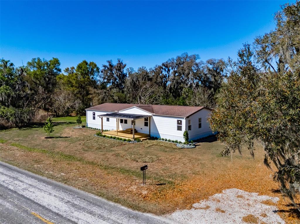 8301 Henry George Road Plant City, FL 33567 - Photo 38 of 51 a view of a house with a tree in the background